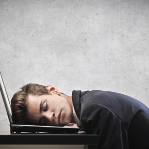 Businessman sleeping on his laptop